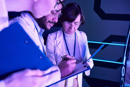 Futuristic Documentation: Three Scientists Record Parameters in Neon-Lit Science Center