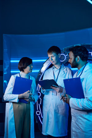 Two scientists and an intern collaborate at a futuristic research center