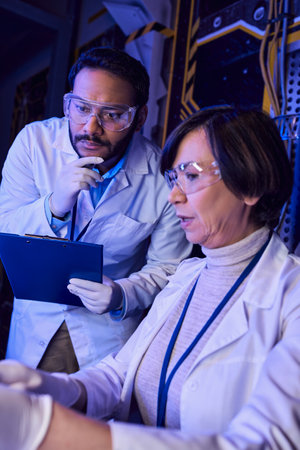 forward-thinking multiethnic colleagues exploring extraterrestrial life in innovative laboratoryの写真素材