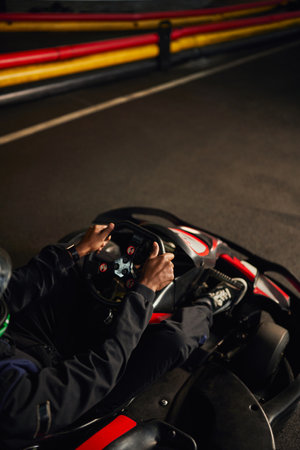 top view of african american go cart racer driving on indoor circuit, speed racing and motorsportの写真素材