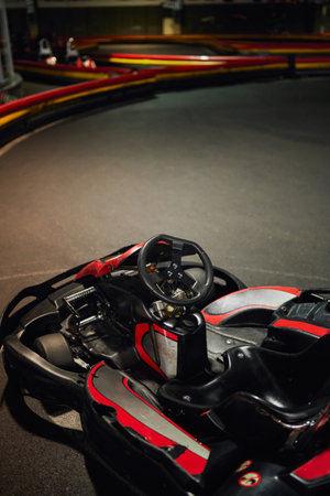 go cart kart for racing, red racing car inside of indoor kart circuit, motor race vehicle