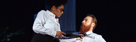 african american woman seducing bearded businessman and pulling his tie in night office, banner