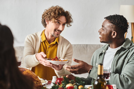 young multicultural relatives sitting at holiday table and sharing food with each other, Christmasの写真素材
