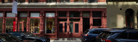 vintage building and cars moving on roadway of downtown district in new york city, banner