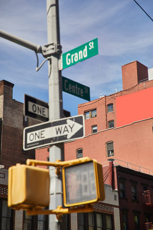 buildings and traffic signs showing directions on crossroad in new york city, urban signageの写真素材
