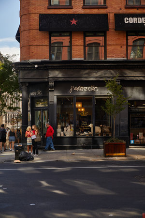 NEW YORK, USA - NOVEMBER 26, 2022: people near Jadore clic home decor boutique in soho district
