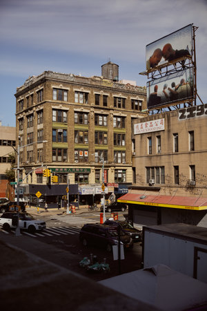 NEW YORK, USA - NOVEMBER 26, 2022: cars and pedestrians on busy street in chinatown