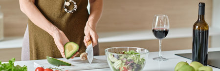 cropped banner, woman cutting ripe avocado near fresh ingredients and red wine, home cooking