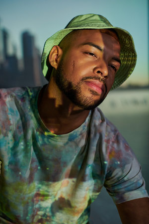 portrait of handsome stylish male model in panama in digital projector lights, fashion conceptの写真素材