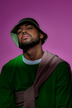young bearded african american man in green sweatshirt with diamond earring, fashion conceptの写真素材