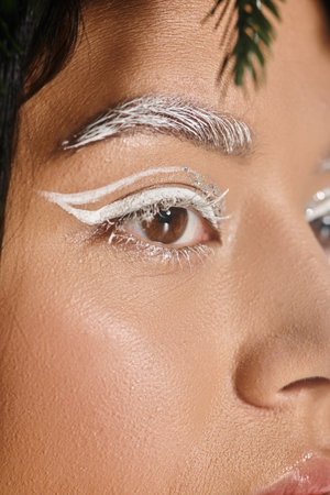 beauty, close up of pretty woman with winter eye makeup looking away, white eyebrows and eyelinerの写真素材