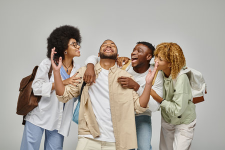 cheerful young students having great time laughing and gesturing actively, studying conceptの写真素材