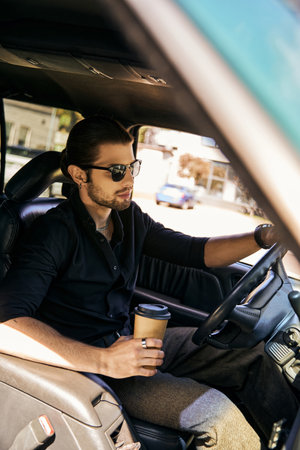 tempting driver with earring and wristwatch holding coffee cup while sitting behind steering wheel