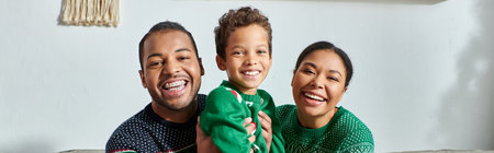 happy african american family posing together and smiling joyfully at camera, Christmas, bannerの写真素材