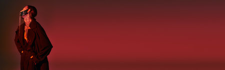 sexy young man with stylish tattoos and laced mask with hands in pockets, fashion concept, bannerの写真素材