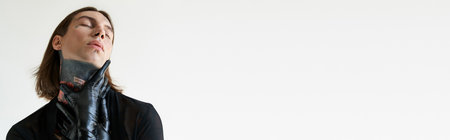 alluring man in transparent shirt with hands in leather gloves on neck, fashion concept, bannerの写真素材