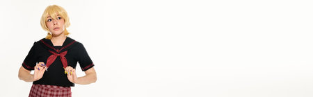 thoughtful anime woman in blonde wig touching red neckerchief and looking away on white, banner