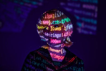 portrait of young anime woman in colorful neon programming symbols projection on blue backdropの写真素材