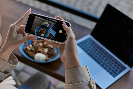 cropped view of woman taking photo on her smartphone of belgian waffles with ice cream, female handsの写真素材