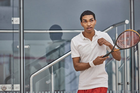 athletic african american sportsman playing squash inside of court, challenge and motivationの写真素材
