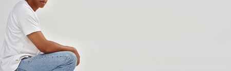 stylish african american man in casual jeans and white t-shirt, copy space for advertising, banner