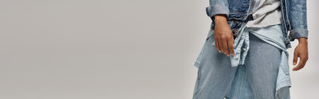 cropped view of stylish african american man posing in trendy denim outfit, fashion concept, bannerの写真素材
