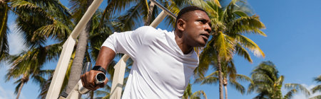 low angle view of african american sportsman working out in Miami beach, bannerの写真素材