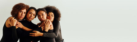 young sexy african american female friends in alluring bodysuits posing together, fashion, bannerの写真素材