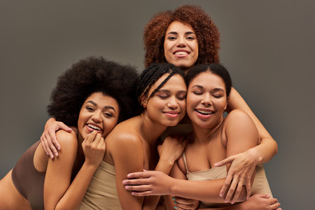 beautiful cheerful african american women in underwear having great time together, fashion conceptの写真素材