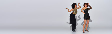 two beautiful african american female friend spending time together partying actively, bannerの写真素材