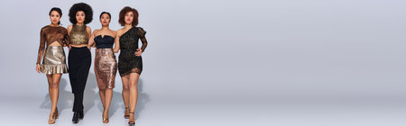 four attractive african american woman in party outfits spending time together, fashion, bannerの写真素材