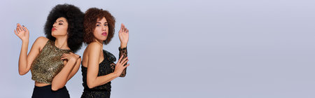 two beautiful african american female friend spending time together partying actively, bannerの写真素材