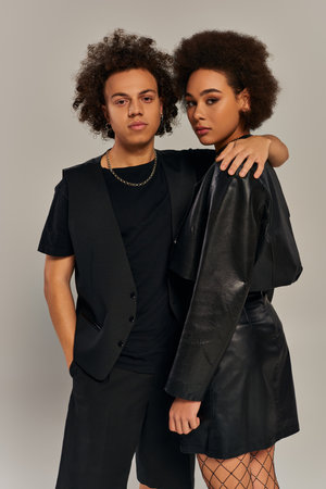 good looking trendy african american siblings in stylish outfits hugging warmly, family conceptの写真素材