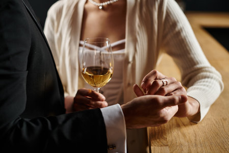 cropped view of man holding hand of woman during date on Valentine`s day, romance and loveの写真素材