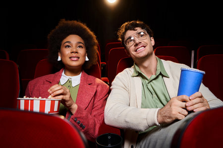 jolly multicultural couple in retro stylish clothes watching movie together on date, Valentines dayの写真素材