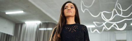 charming african american dancer in black knitted sweater rehearsing in dance hall, banner
