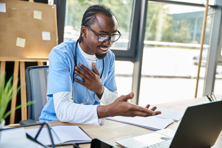 young joyful african american doctor with glasses consulting someone by phone and gesturing actively
