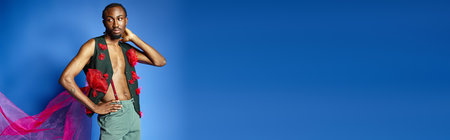 young african american man in stylish attire on blue backdrop looking away, fashion concept, bannerの写真素材