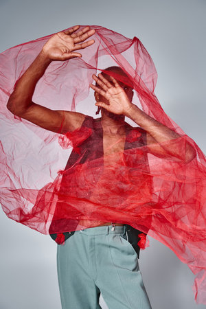 good looking young african american man posing with hands in front of his face, fashion conceptの写真素材