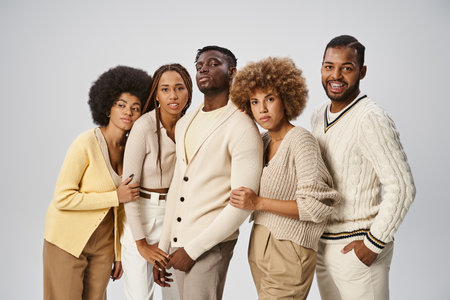 five african american friends in casual attire standing on grey background, Juneteenth concept
