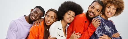 happy african american community in casual attire leaning on each other, Juneteenth bannerの写真素材