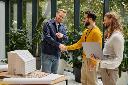 good looking happy architects in casual clothes working together on their startup, coworking concept