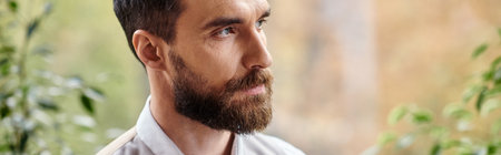 handsome focused leader with beard in sophisticated attire looking away, business concept, bannerの写真素材