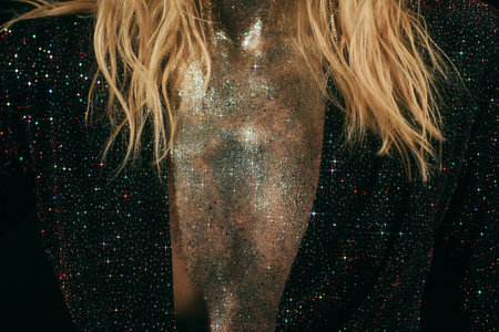 cropped shot of woman with sparkling glitter on chest and jacket with sequins on black backgroundの写真素材