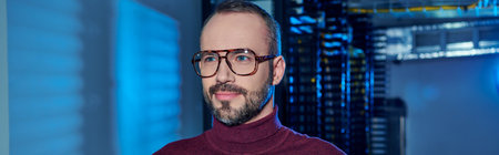 joyful focused data center specialist in turtleneck with beard and glasses looking away, information
