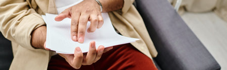 cropped view of indian blind man in casual attire sitting and reading braille code, banner