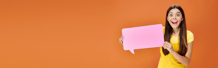 cheerful adolescent girl in vibrant attire holding speech bubble and looking at camera, banner