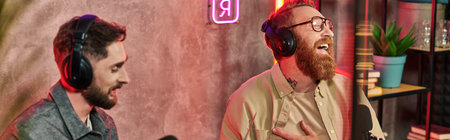 handsome men in casual attires posing with laptop during their discussion on podcast, banner