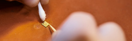 cropped view of skilled technician cleaning chipset microscheme of electronic device, banner