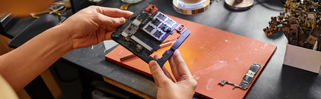 cropped view of equipment repairment holding chipset in modern service shop, horizontal bannerの写真素材